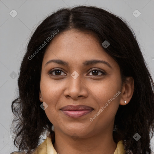 Joyful black young-adult female with long  brown hair and brown eyes