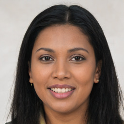 Joyful latino young-adult female with long  brown hair and brown eyes