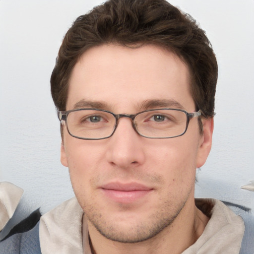 Joyful white young-adult male with short  brown hair and blue eyes