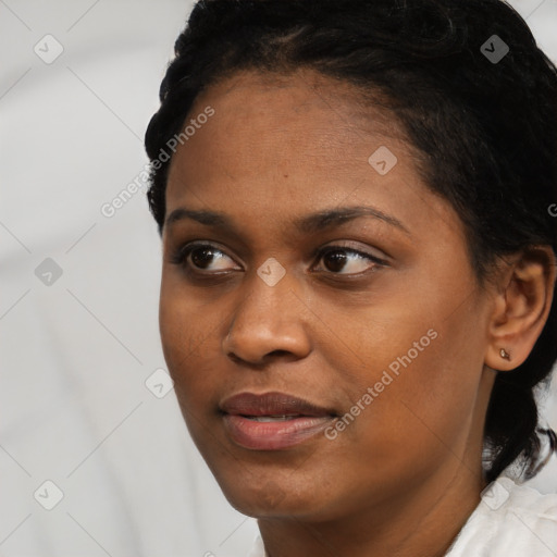 Joyful black young-adult female with short  black hair and brown eyes