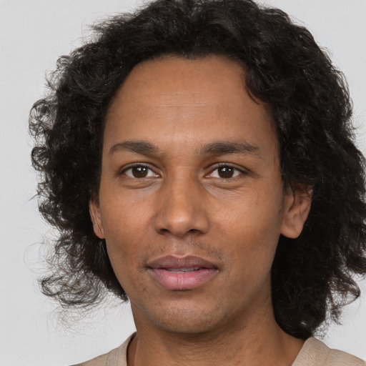 Joyful black adult male with short  brown hair and brown eyes