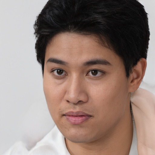 Joyful asian young-adult male with short  brown hair and brown eyes