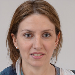 Joyful white adult female with medium  brown hair and grey eyes