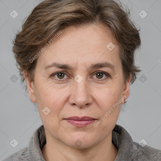 Joyful white adult female with short  brown hair and blue eyes