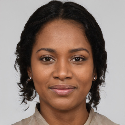 Joyful black young-adult female with medium  black hair and brown eyes