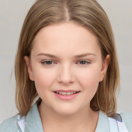 Joyful white child female with medium  brown hair and grey eyes