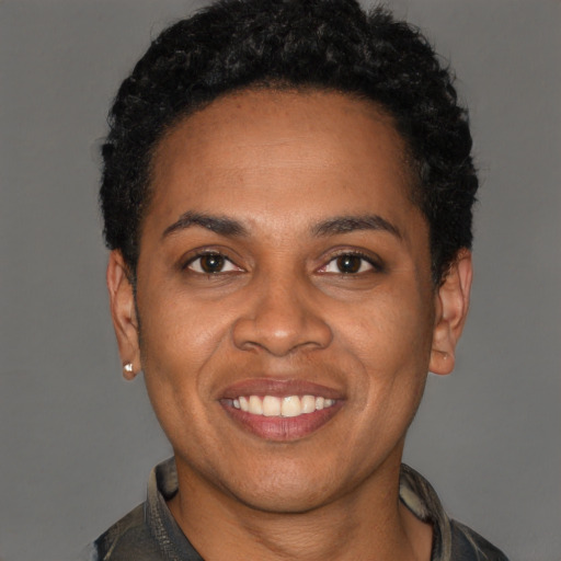 Joyful latino young-adult female with short  black hair and brown eyes
