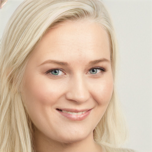 Joyful white young-adult female with long  blond hair and blue eyes