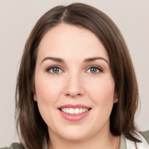 Joyful white young-adult female with medium  brown hair and grey eyes