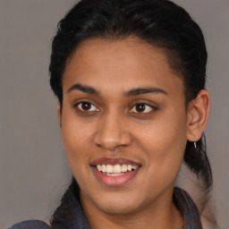 Joyful latino young-adult female with short  brown hair and brown eyes