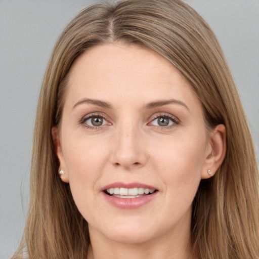 Joyful white young-adult female with long  brown hair and grey eyes