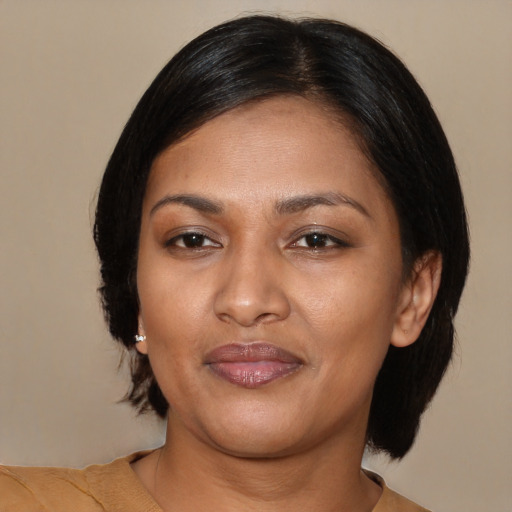 Joyful latino adult female with medium  black hair and brown eyes