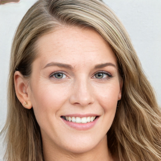 Joyful white young-adult female with long  brown hair and blue eyes