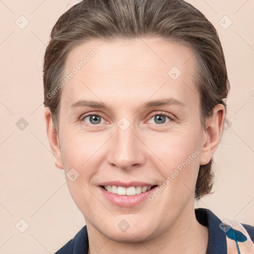 Joyful white young-adult female with medium  brown hair and grey eyes