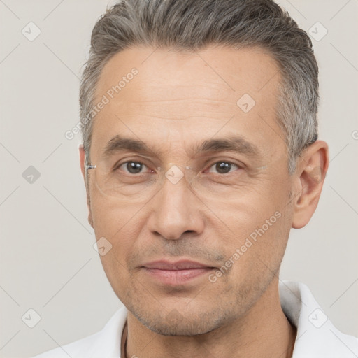 Joyful white adult male with short  brown hair and brown eyes