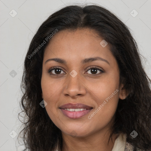 Joyful black young-adult female with long  brown hair and brown eyes