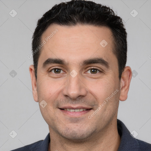 Joyful white young-adult male with short  black hair and brown eyes