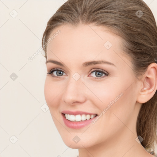 Joyful white young-adult female with medium  brown hair and blue eyes