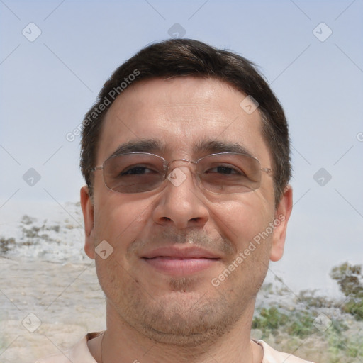 Joyful white adult male with short  brown hair and brown eyes