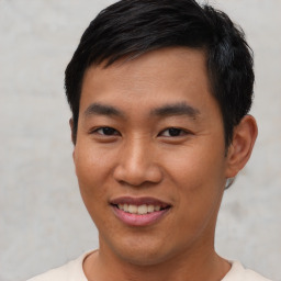 Joyful asian young-adult male with short  black hair and brown eyes