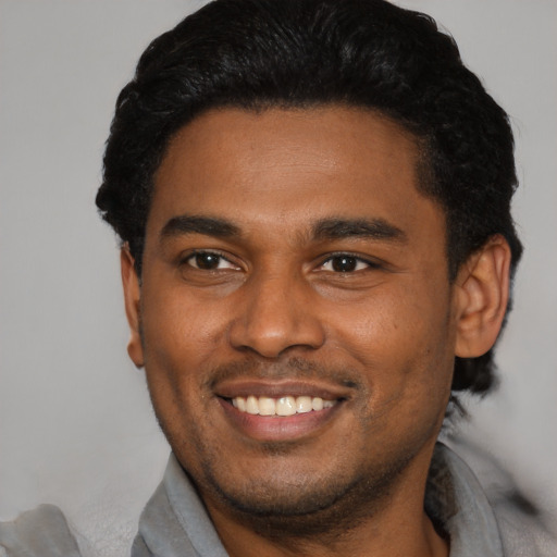Joyful latino young-adult male with short  black hair and brown eyes