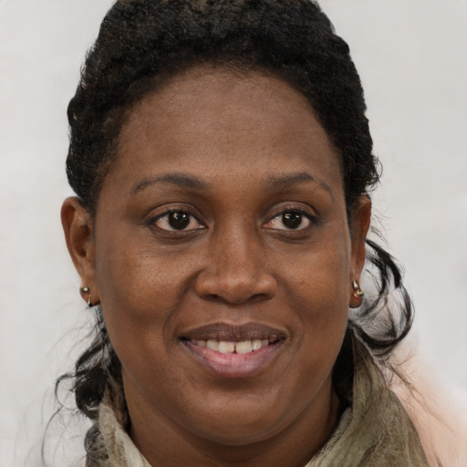 Joyful black adult female with medium  brown hair and brown eyes