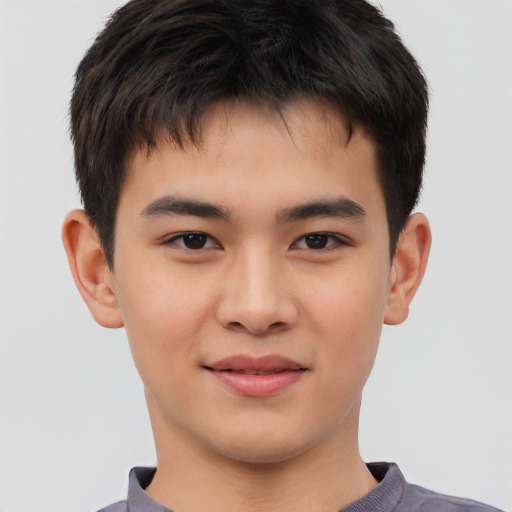 Joyful asian child male with short  brown hair and brown eyes