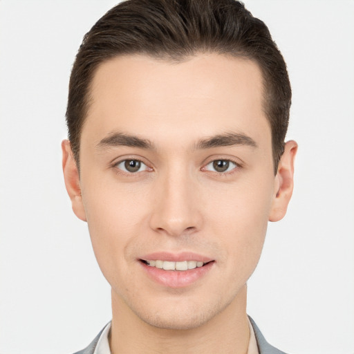 Joyful white young-adult male with short  brown hair and brown eyes