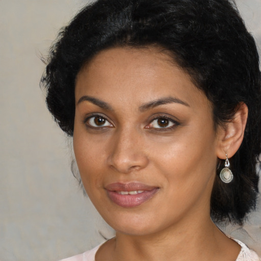 Joyful black young-adult female with medium  black hair and brown eyes