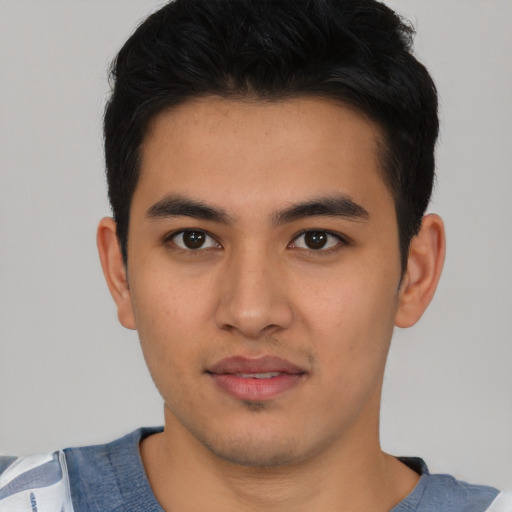 Joyful asian young-adult male with short  black hair and brown eyes