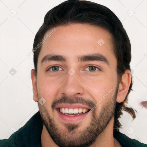 Joyful white young-adult male with short  black hair and brown eyes