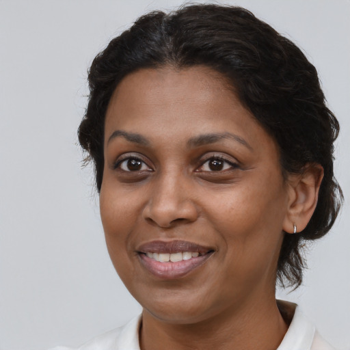 Joyful black young-adult female with medium  brown hair and brown eyes