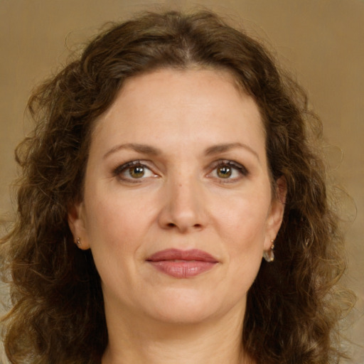 Joyful white adult female with long  brown hair and green eyes