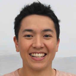 Joyful asian young-adult male with short  black hair and brown eyes