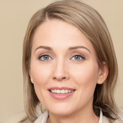 Joyful white young-adult female with medium  brown hair and grey eyes