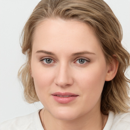 Joyful white young-adult female with medium  brown hair and blue eyes