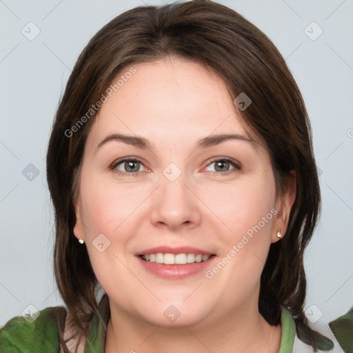 Joyful white young-adult female with medium  brown hair and green eyes