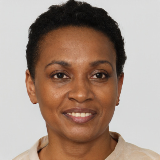 Joyful black young-adult female with short  black hair and brown eyes