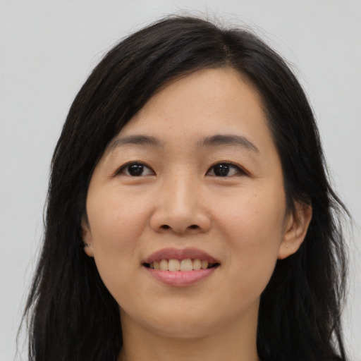 Joyful asian young-adult female with long  black hair and brown eyes