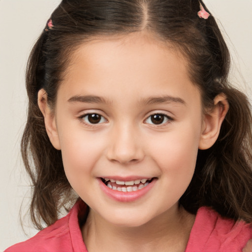 Joyful white child female with medium  brown hair and brown eyes