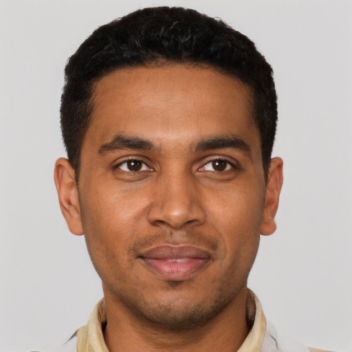 Joyful black young-adult male with short  brown hair and brown eyes
