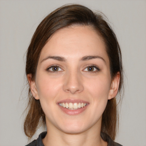 Joyful white young-adult female with medium  brown hair and brown eyes