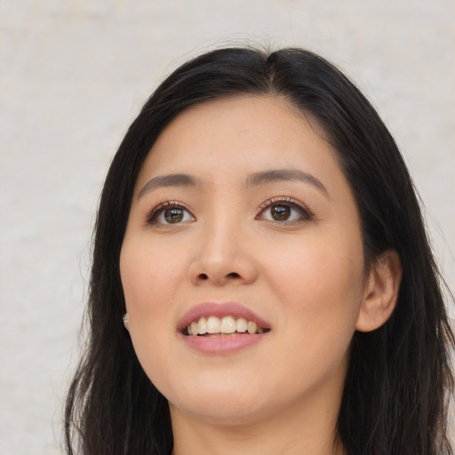 Joyful asian young-adult female with long  black hair and brown eyes