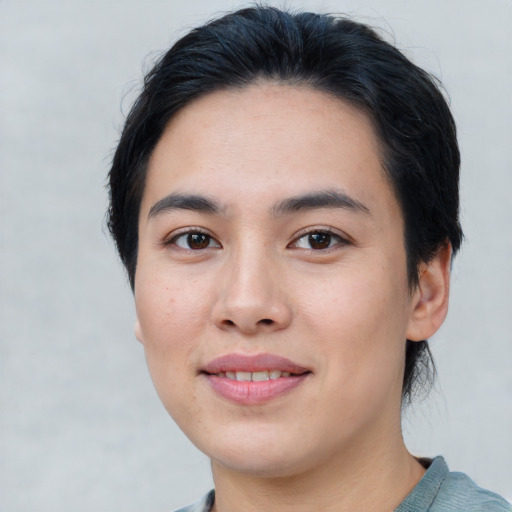 Joyful white young-adult female with short  black hair and brown eyes