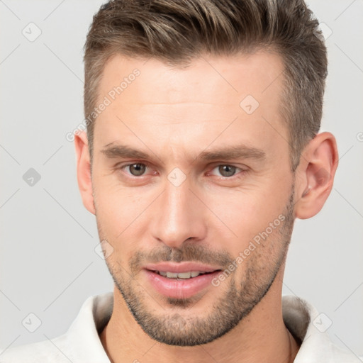 Joyful white young-adult male with short  brown hair and brown eyes