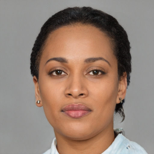 Joyful black young-adult female with short  brown hair and brown eyes