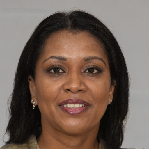 Joyful black adult female with medium  brown hair and brown eyes