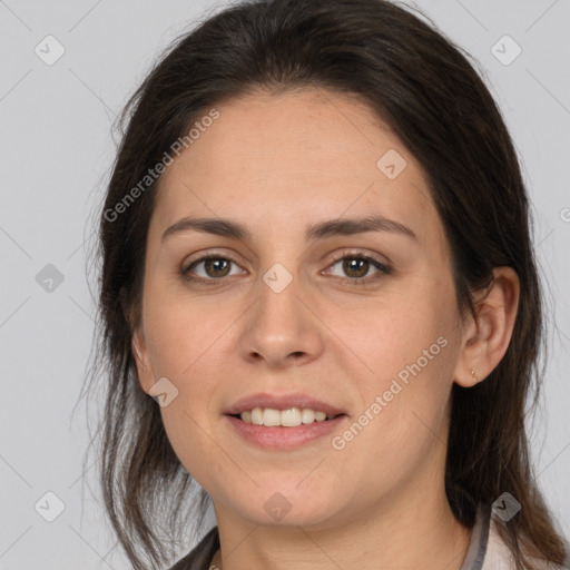 Joyful white young-adult female with long  brown hair and brown eyes