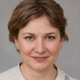 Joyful white adult female with medium  brown hair and grey eyes