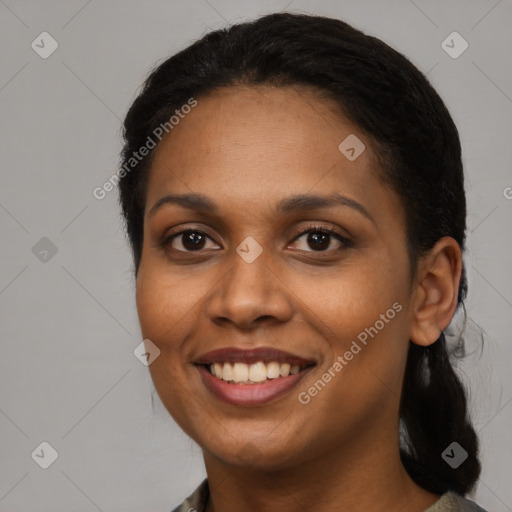 Joyful black young-adult female with long  black hair and brown eyes